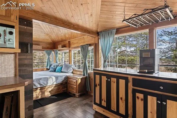 a bedroom with furniture and large window