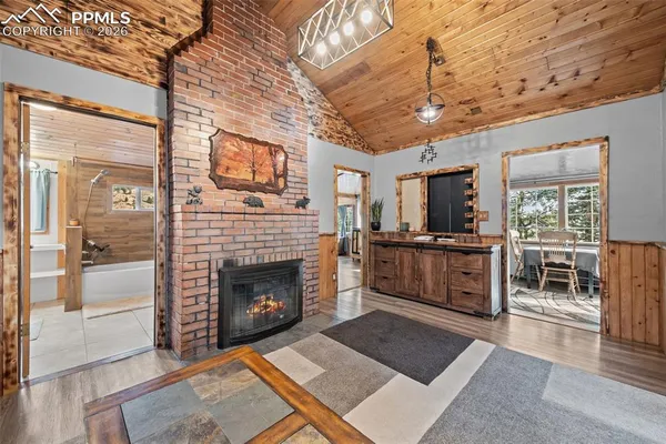 a living room with furniture a fireplace and a table