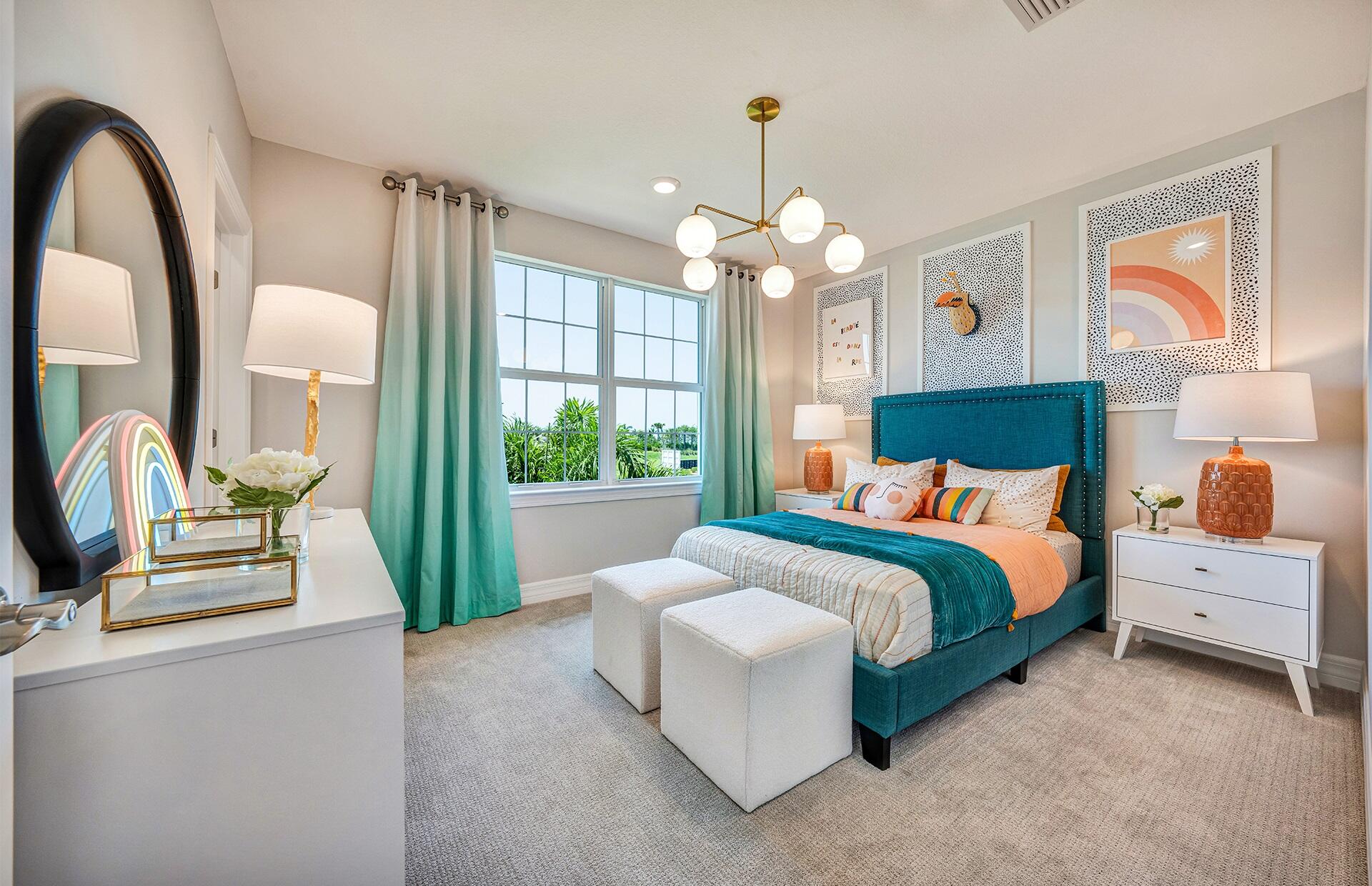 4340 Southwest Cornerstone Way, Unit WHITESTONE 136 Stuart, FL 34997 - Photo 21 of 34 a bedroom with a large bed and a chandelier