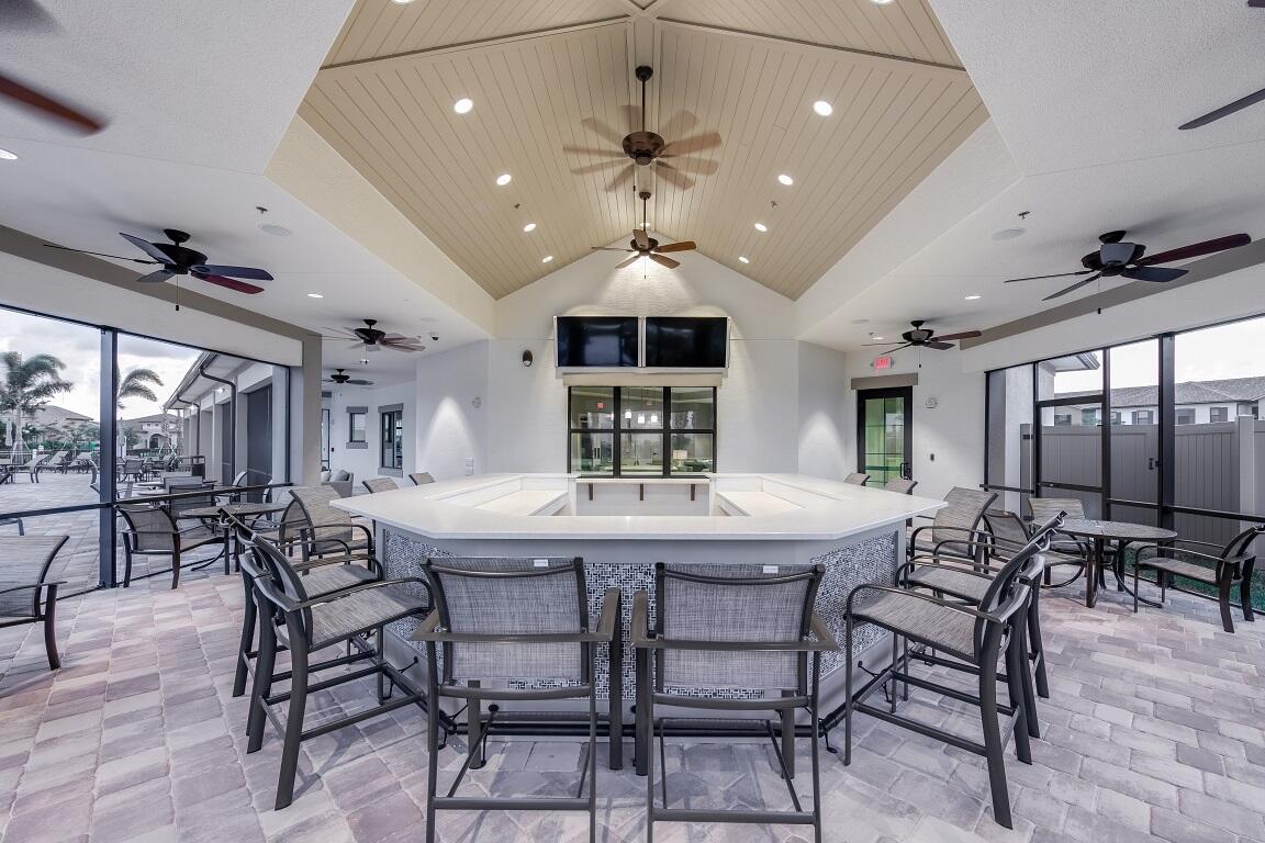 4340 Southwest Cornerstone Way, Unit WHITESTONE 136 Stuart, FL 34997 - Photo 27 of 34 a view of a dining room with furniture window and wooden floor