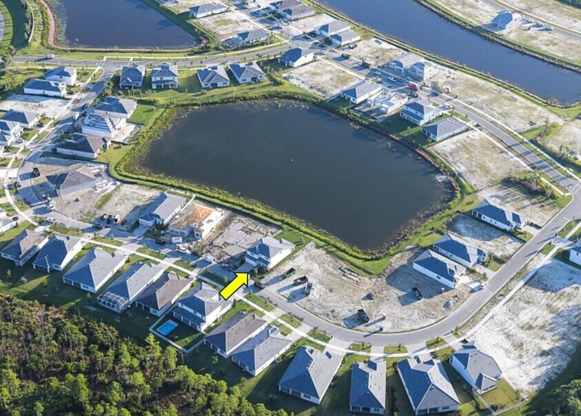 4340 Southwest Cornerstone Way, Unit WHITESTONE 136 Stuart, FL 34997 - Photo 2 of 34 an aerial view of a house with a yard