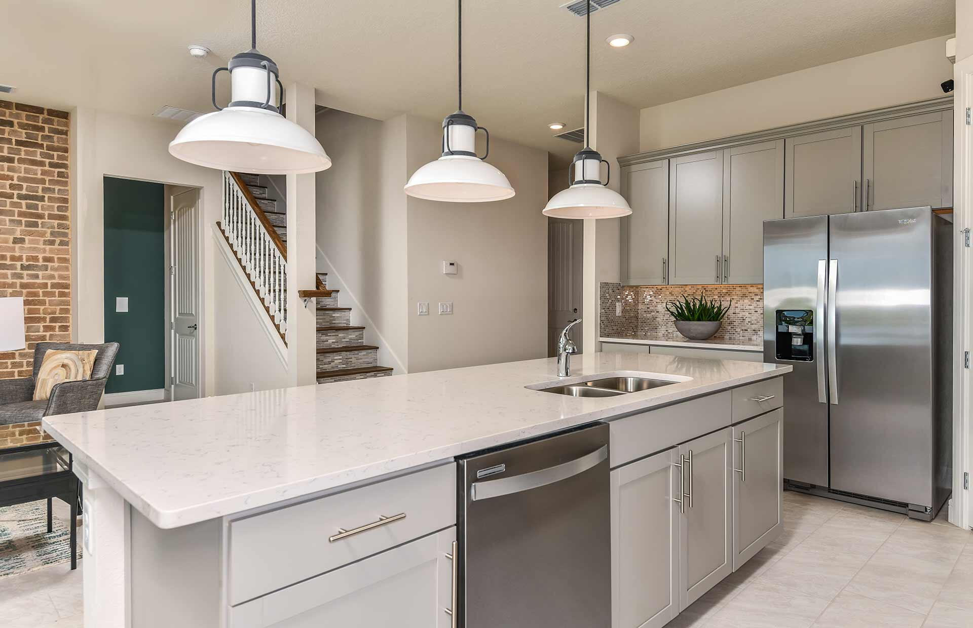 4340 Southwest Cornerstone Way, Unit WHITESTONE 136 Stuart, FL 34997 - Photo 8 of 34 a kitchen with stainless steel appliances a table and chairs
