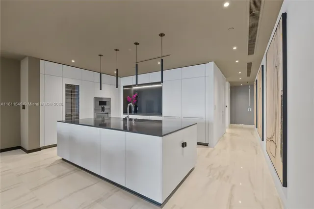 a large white kitchen with a large window