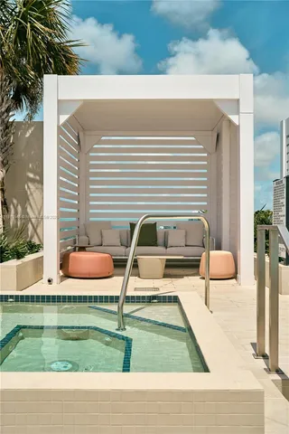 a living room with couches and painted wall next to a window