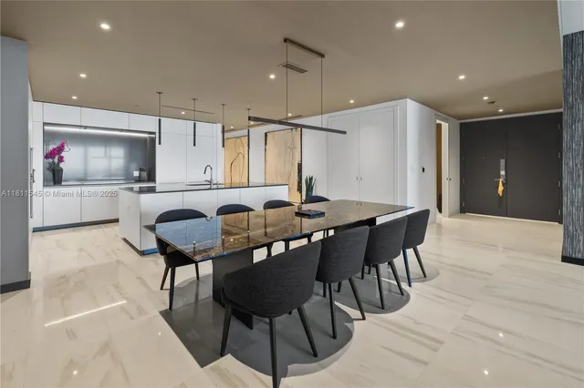 a kitchen with stainless steel appliances granite countertop a sink a counter top space and living room view