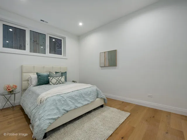 a bedroom with a bed and a night stand