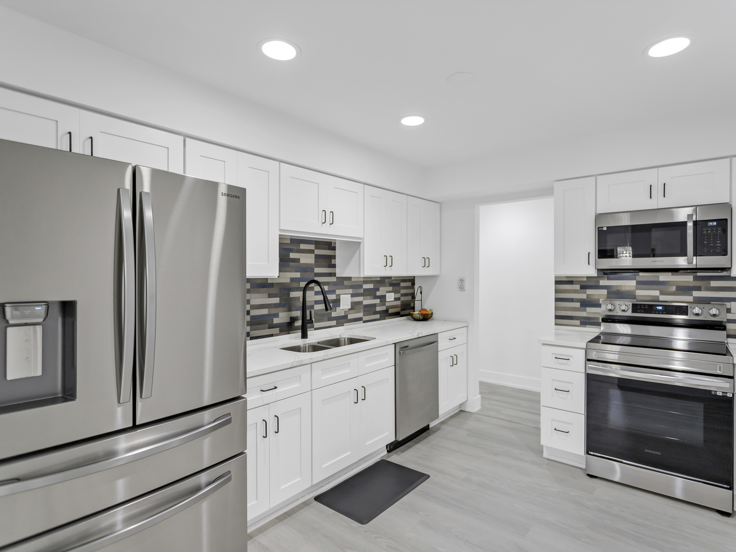 1535 South County Farm Road, Unit 12D Wheaton, IL 60189 - Photo 3 of 24 a kitchen with stainless steel appliances a refrigerator stove and microwave