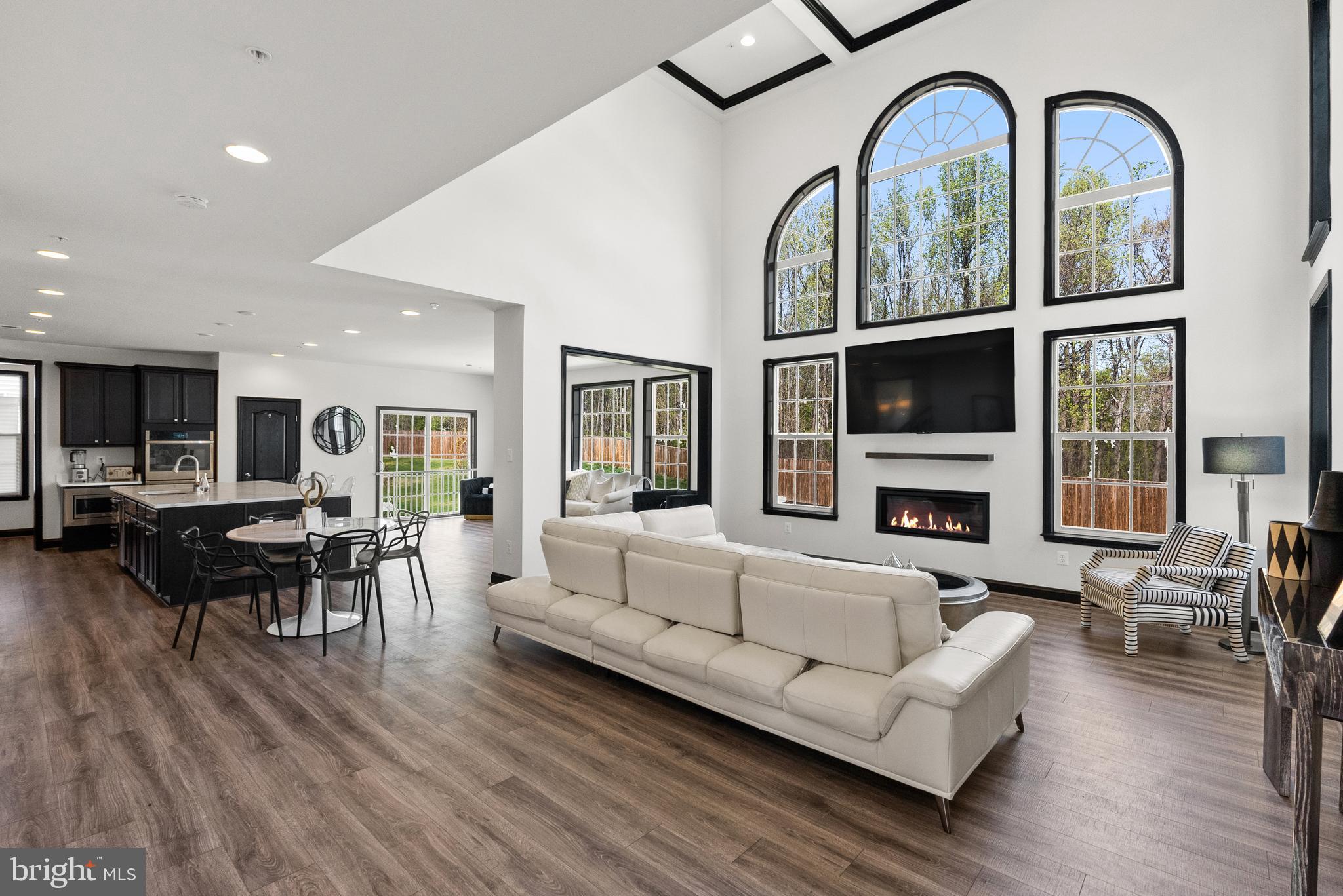 4012 Diamondhead Avenue Bowie, MD 20721 - Photo 16 of 96 a living room with furniture a fireplace and a floor to ceiling window