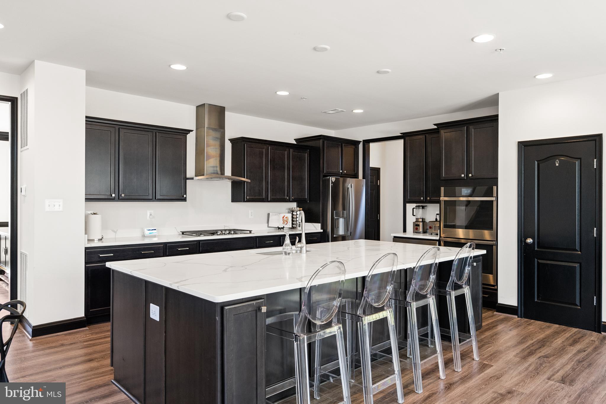 4012 Diamondhead Avenue Bowie, MD 20721 - Photo 25 of 96 a kitchen with stainless steel appliances a sink stove refrigerator and cabinets
