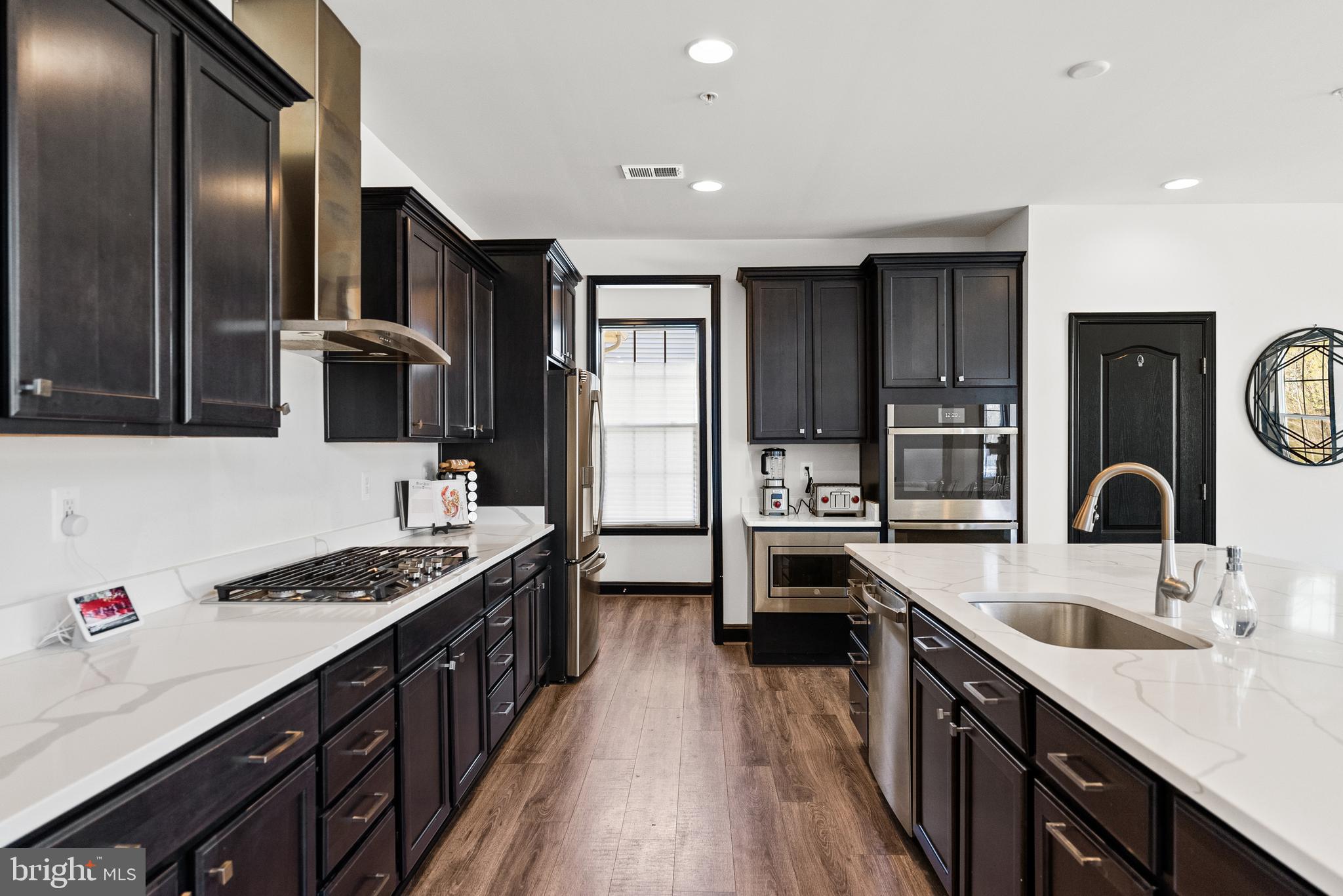 4012 Diamondhead Avenue Bowie, MD 20721 - Photo 27 of 96 a kitchen with stainless steel appliances granite countertop a sink stove and refrigerator