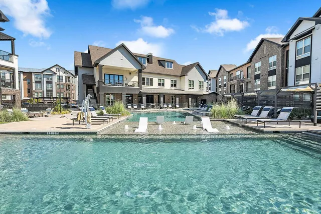 a view of the house with swimming pool and a yard