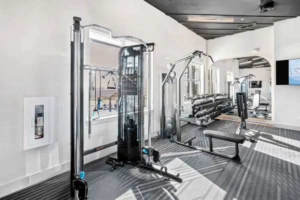 a living room with granite countertop furniture a table and kitchen view