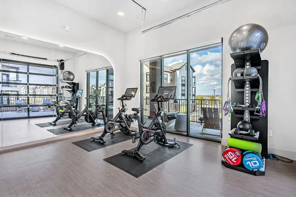a view of a livingroom and a dining room with wooden floor