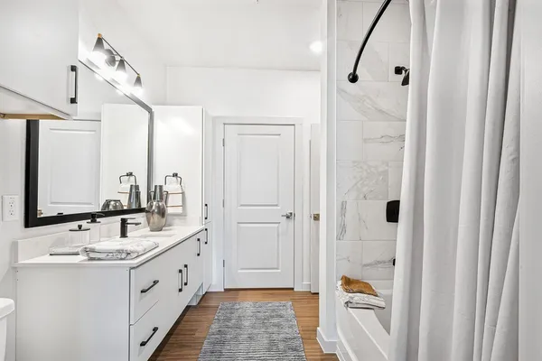 a bathroom with a double vanity sink and mirror
