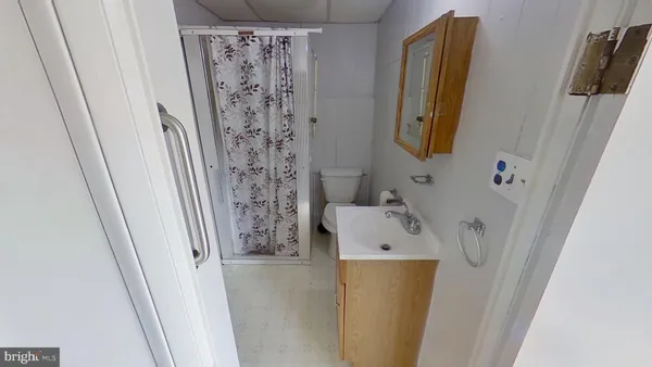 a bathroom with a sink and a shower curtain
