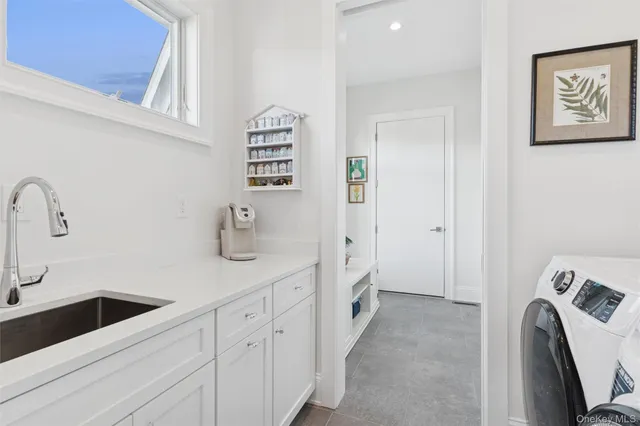 a view of a bathroom with sink dryer and washer