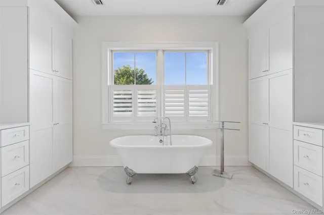 a spacious bathroom with a bathtub and next to a window