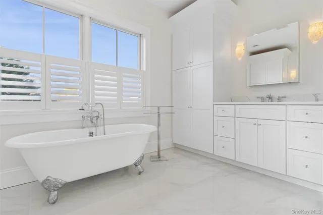 a spacious bathroom with a bathtub and a sink