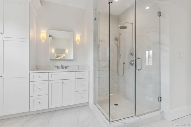 a bathroom with a shower sink and mirror