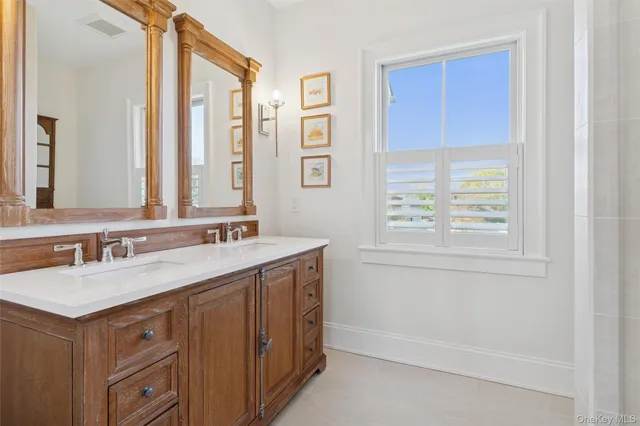 a bathroom with a sink double vanity and a mirror