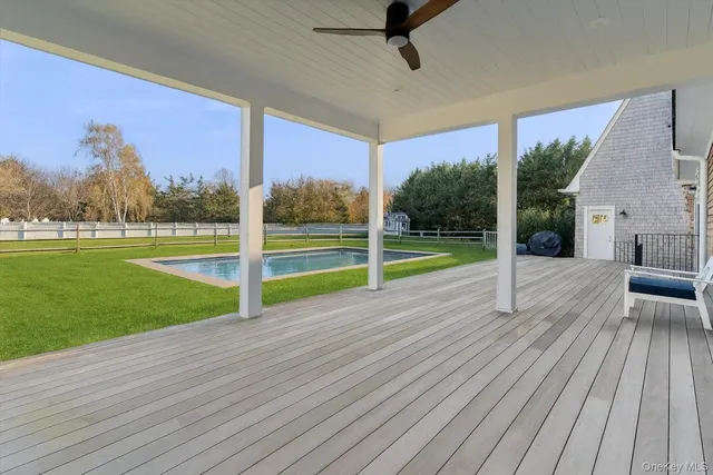a view of a room with wooden floor and a yard