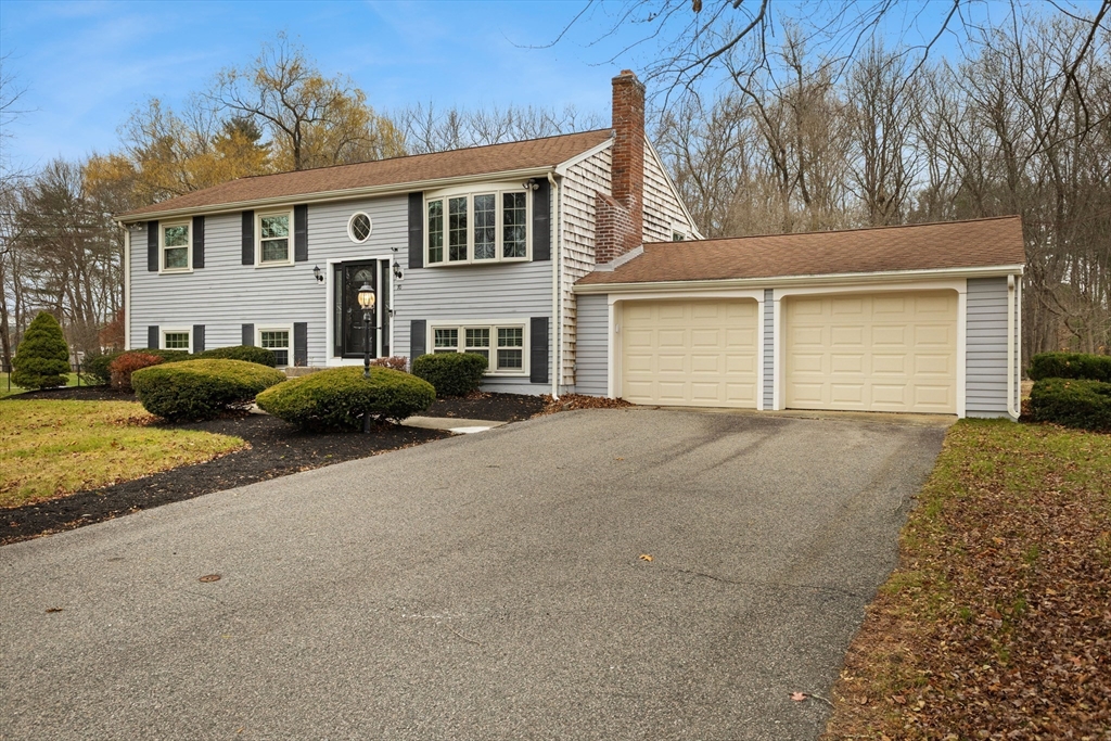 70 Dillingham Way Hanover, MA 02339 - Photo 2 of 42 a front view of a house with a yard and garage