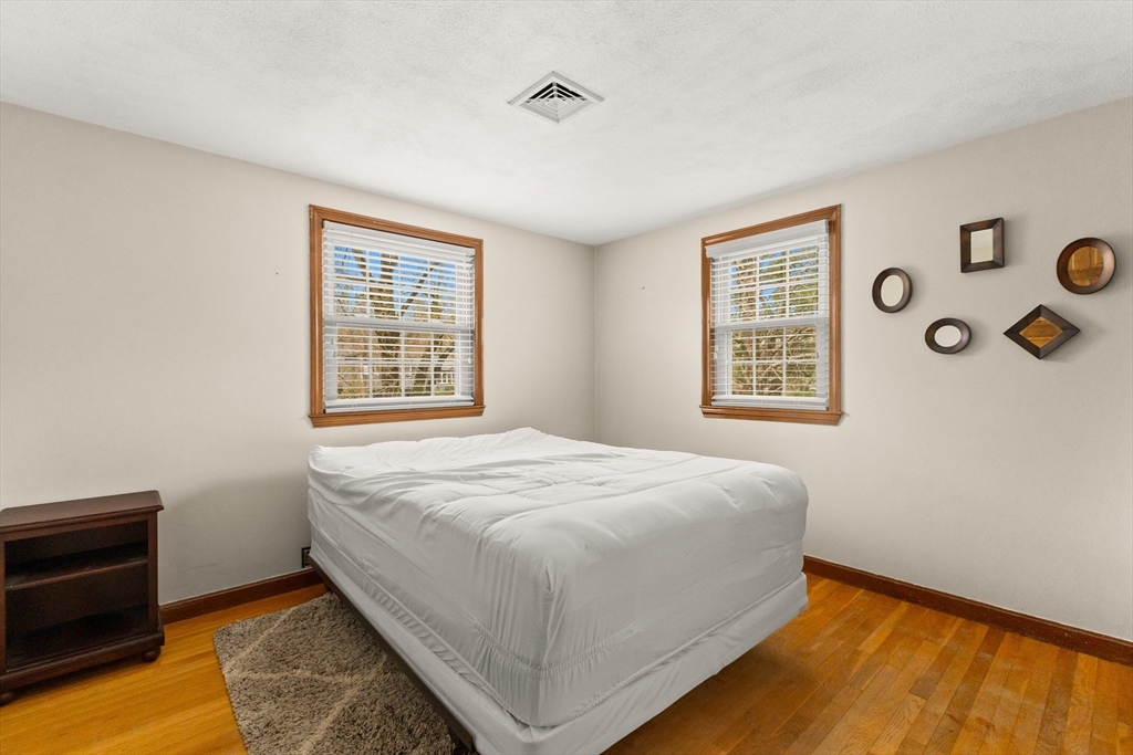 70 Dillingham Way Hanover, MA 02339 - Photo 28 of 42 a bed sitting in a bedroom next to a window