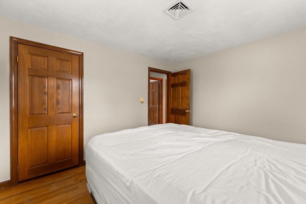 70 Dillingham Way Hanover, MA 02339 - Photo 29 of 42 a bedroom with a bed and wooden floor