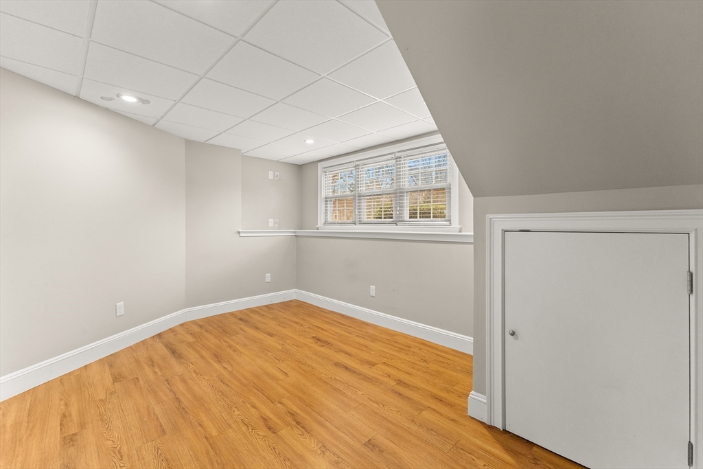70 Dillingham Way Hanover, MA 02339 - Photo 38 of 42 an empty room with wooden floor and windows