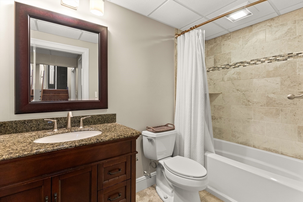 70 Dillingham Way Hanover, MA 02339 - Photo 40 of 42 a bathroom with a granite countertop sink toilet and shower