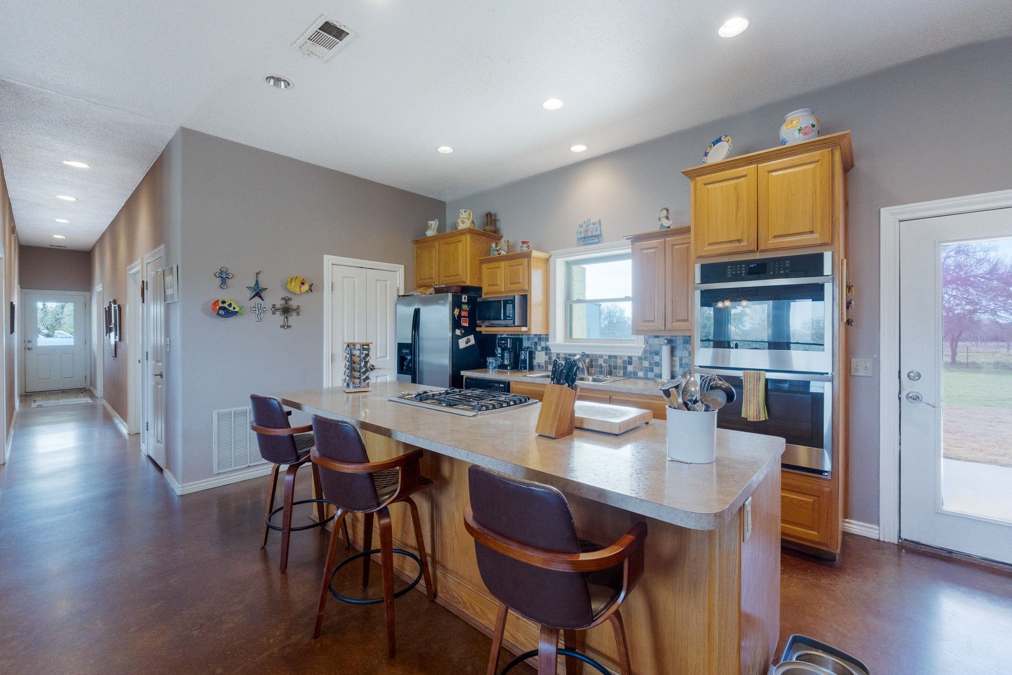 8089 East Fm 580 Kempner, TX 76539 - Photo 16 of 30 a dining room with stainless steel appliances a dining table and chairs