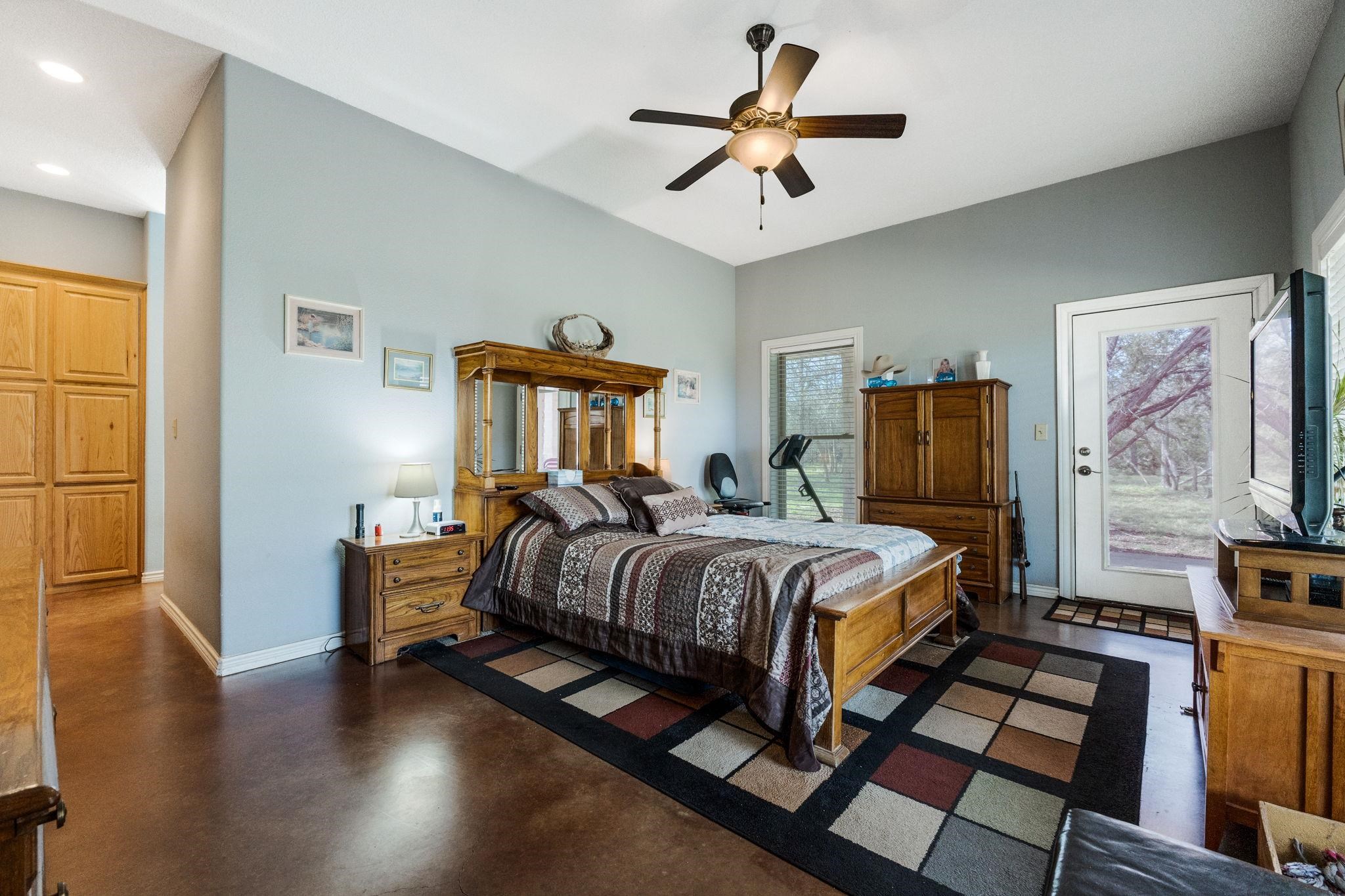 8089 East Fm 580 Kempner, TX 76539 - Photo 21 of 30 a bedroom with a bed and a chandelier