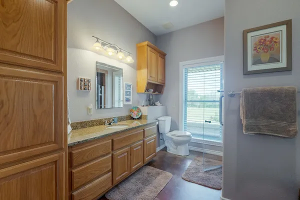 a bathroom with a double vanity sink toilet and a tub
