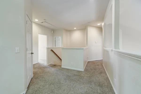 an empty room with windows and entrance