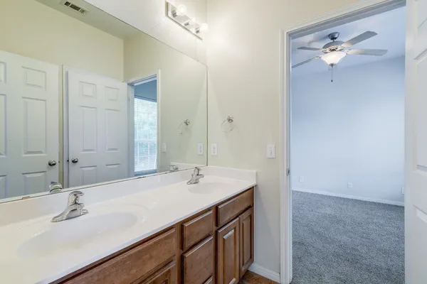 a bathroom with a double vanity sink mirror and