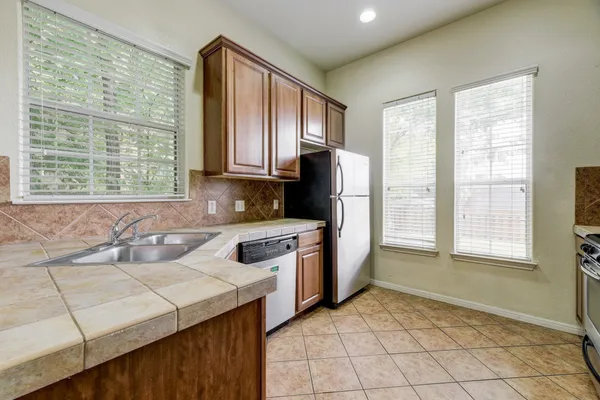 a kitchen with a stove a sink and a refrigerator