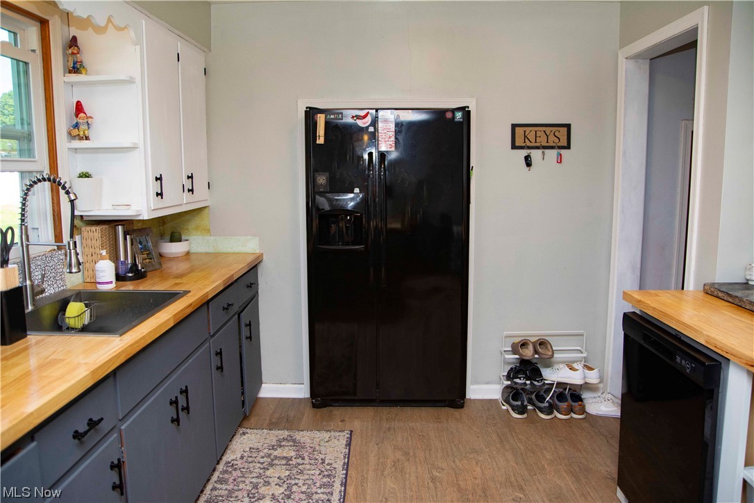 2658 Brunswick Road Youngstown, OH 44511 - Photo 18 of 33 Kitchen with black appliances, white and gray cabinets, light countertops, and new floors