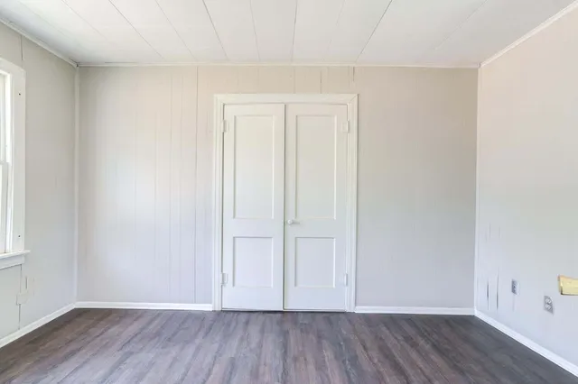 an empty room with wooden floor