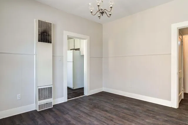 an empty room with wooden floor and closet