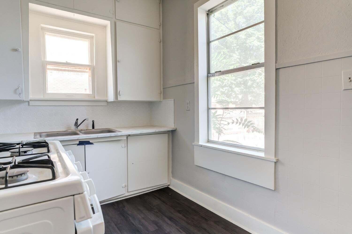 1918 18th Street Lubbock, TX 79401 - Photo 8 of 28 a view of a kitchen with sink and wooden floor