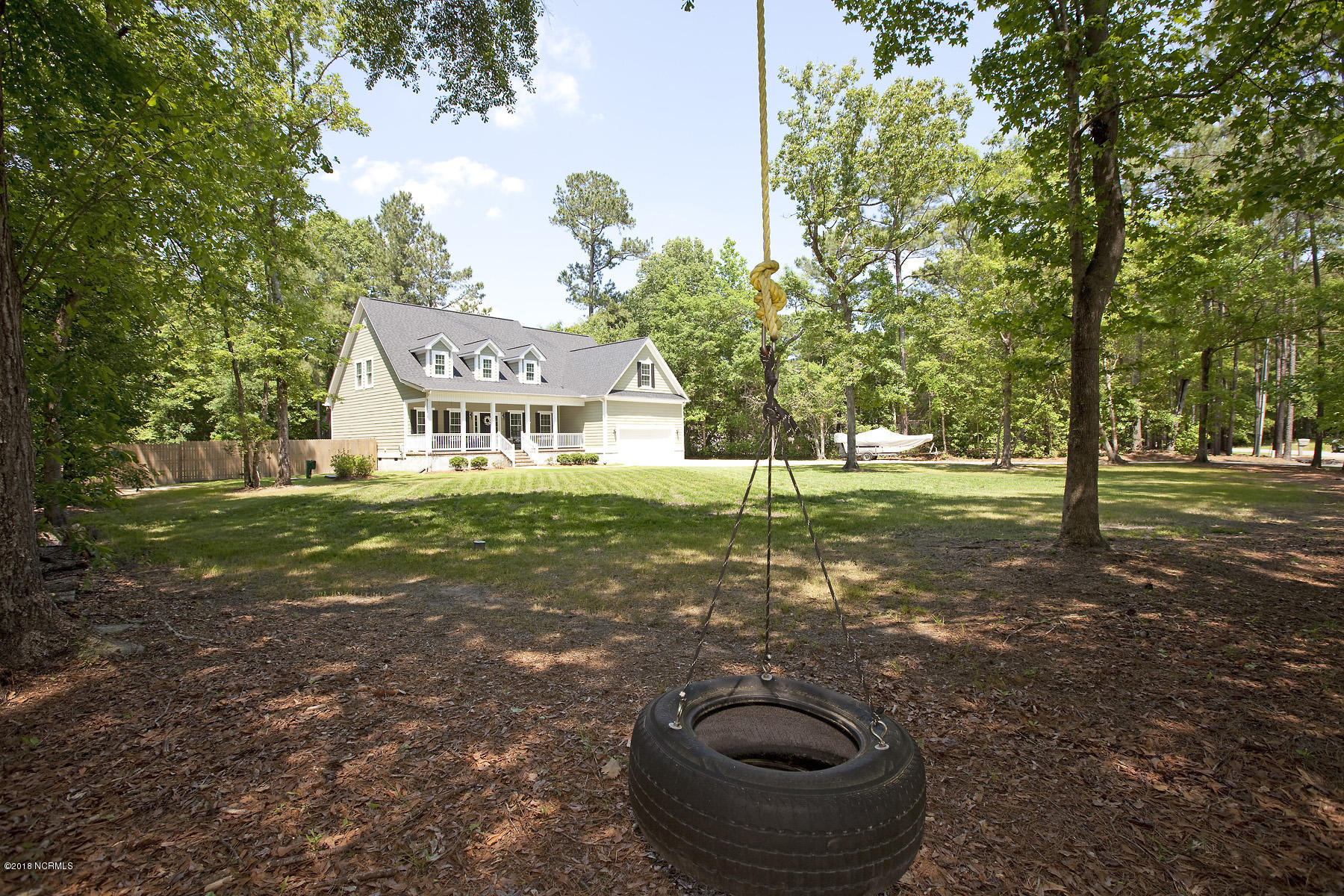 112 Spring Chase Lane Rocky Point, NC 28457 - Photo 55 of 63 Enjoy a tire swing on the lazy warm days in the shade.