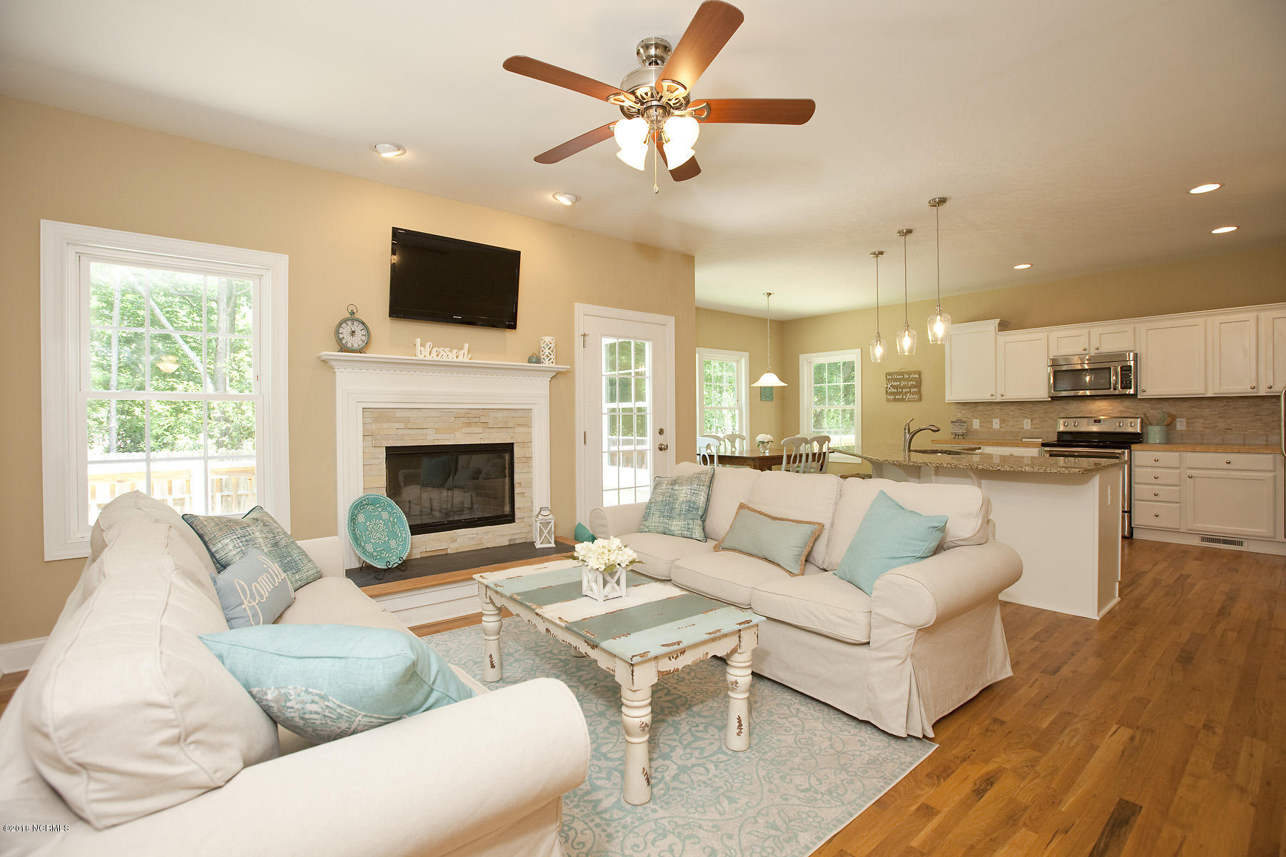 112 Spring Chase Lane Rocky Point, NC 28457 - Photo 6 of 63 Living room with wood burning fireplace.