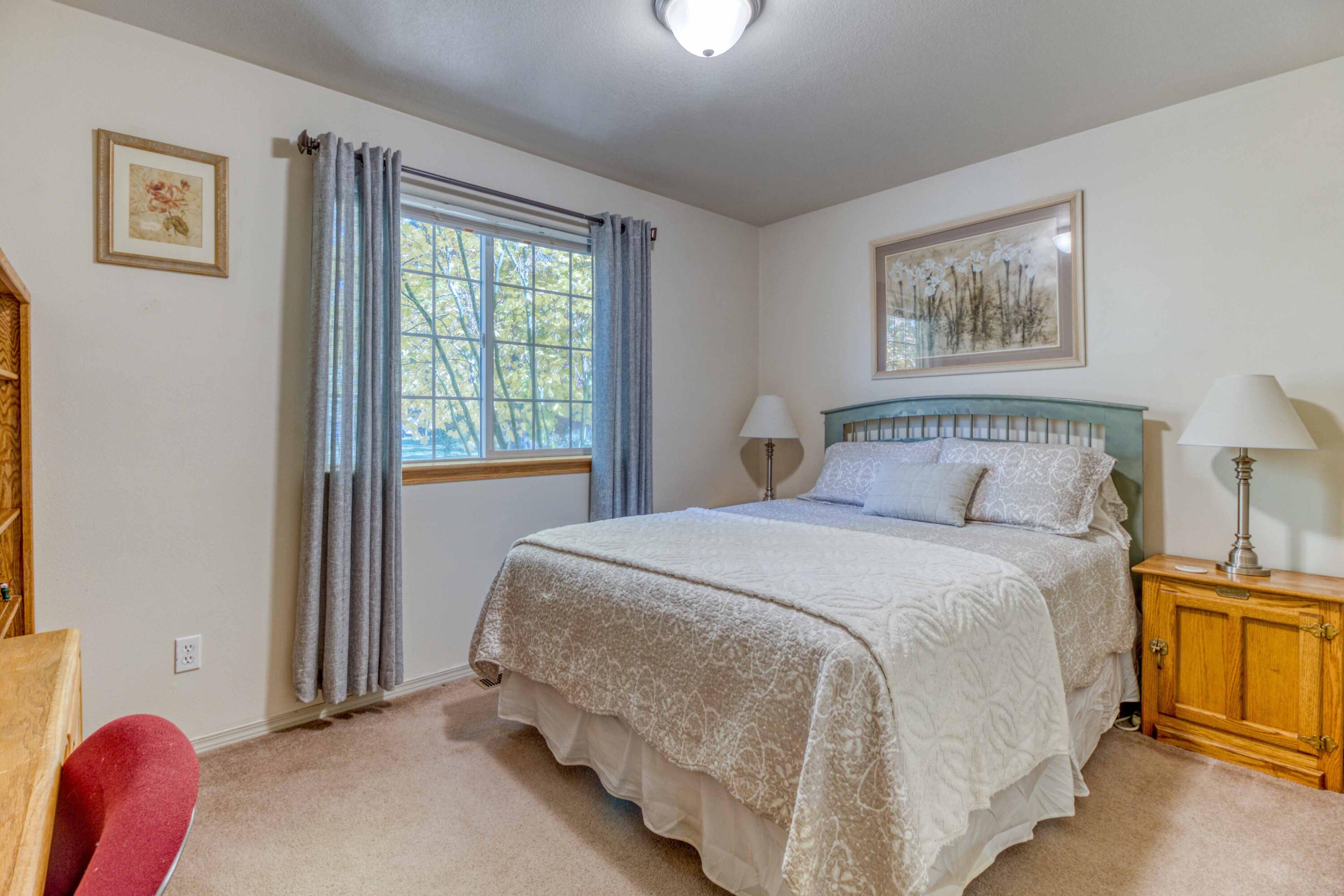 60452 Zuni Road Bend, OR 97702 - Photo 16 of 41 Bedroom 2 down the hallway to the left of the dining area.