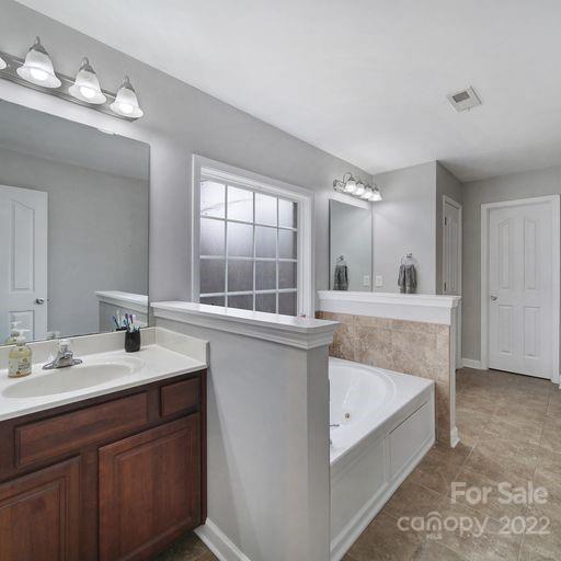 2048 Standing Timber Road Lancaster, SC 29720 - Photo 29 of 39 a bathroom with a tub sink and mirror