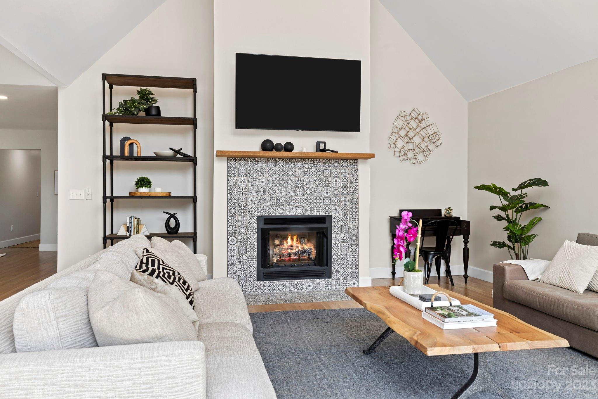188 White Oak Gap Road Asheville, NC 28803 - Photo 17 of 48 a living room with furniture a flat screen tv and a fireplace