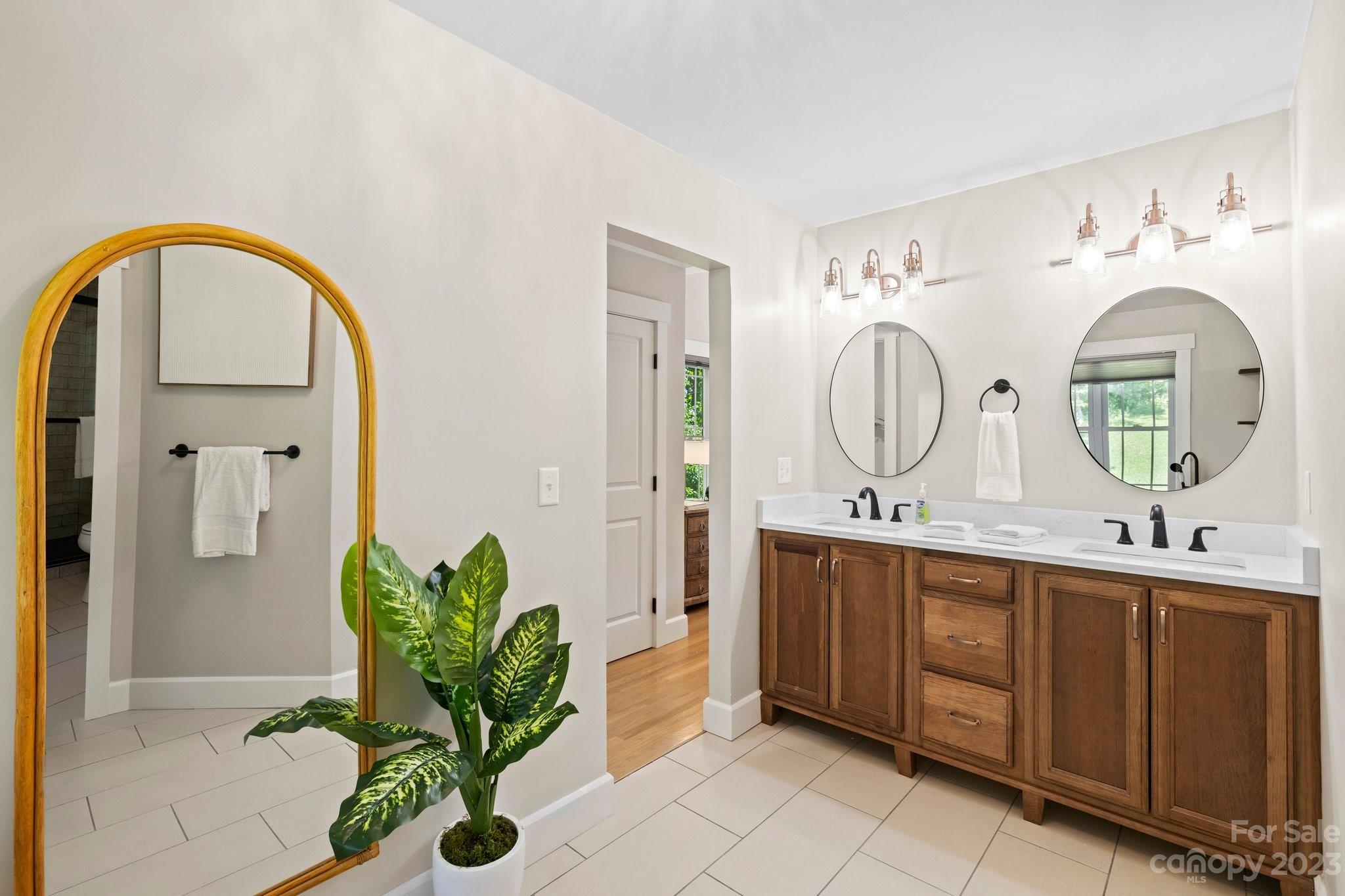 188 White Oak Gap Road Asheville, NC 28803 - Photo 21 of 48 a bathroom with a double vanity sink and a mirror