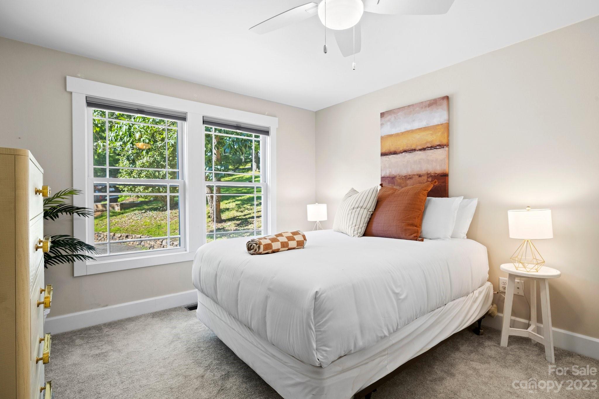 188 White Oak Gap Road Asheville, NC 28803 - Photo 22 of 48 a bedroom with a bed and a window