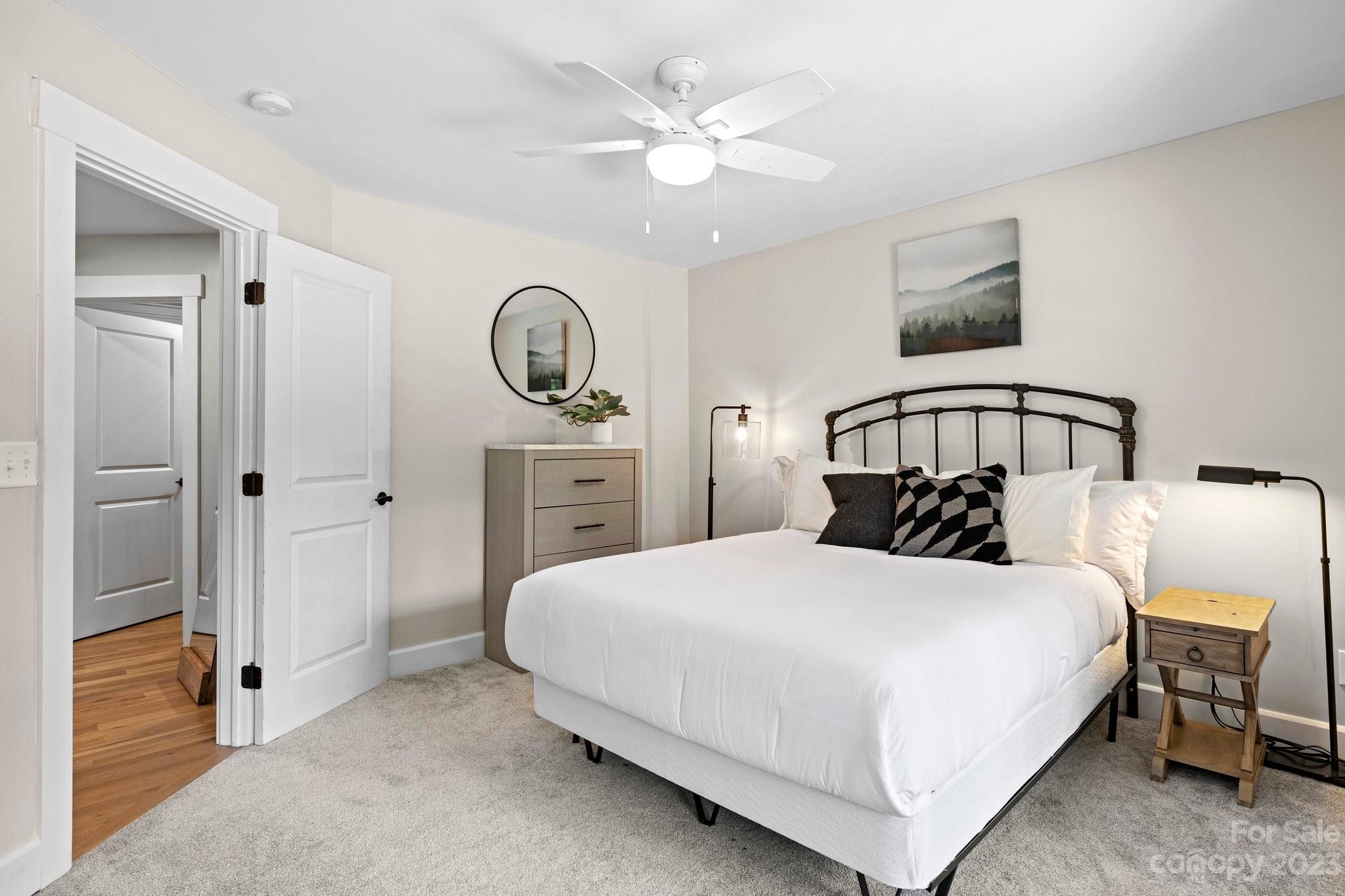 188 White Oak Gap Road Asheville, NC 28803 - Photo 27 of 48 a bedroom with a bed and a chandelier