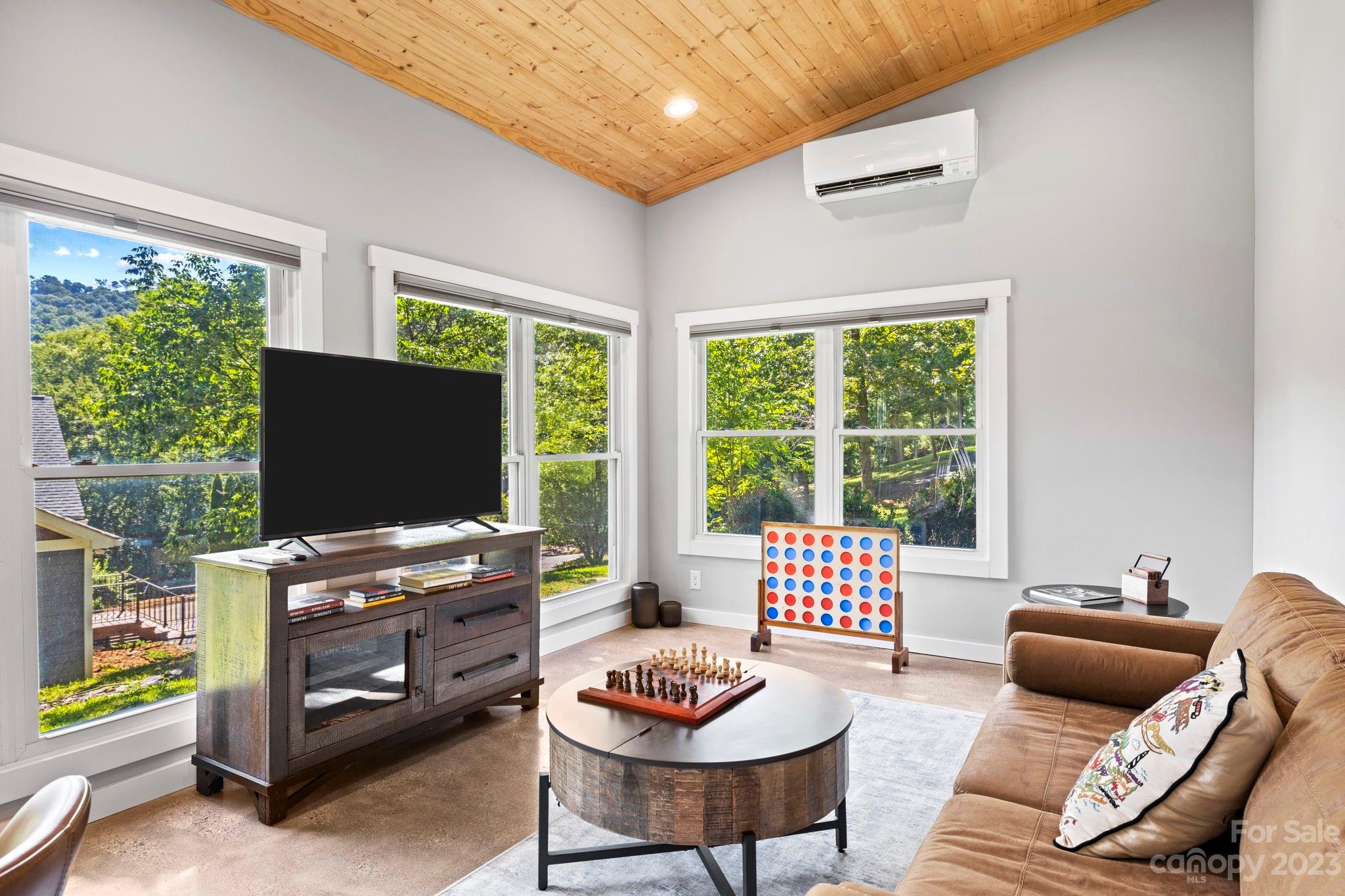 188 White Oak Gap Road Asheville, NC 28803 - Photo 39 of 48 a living room with furniture and a flat screen tv