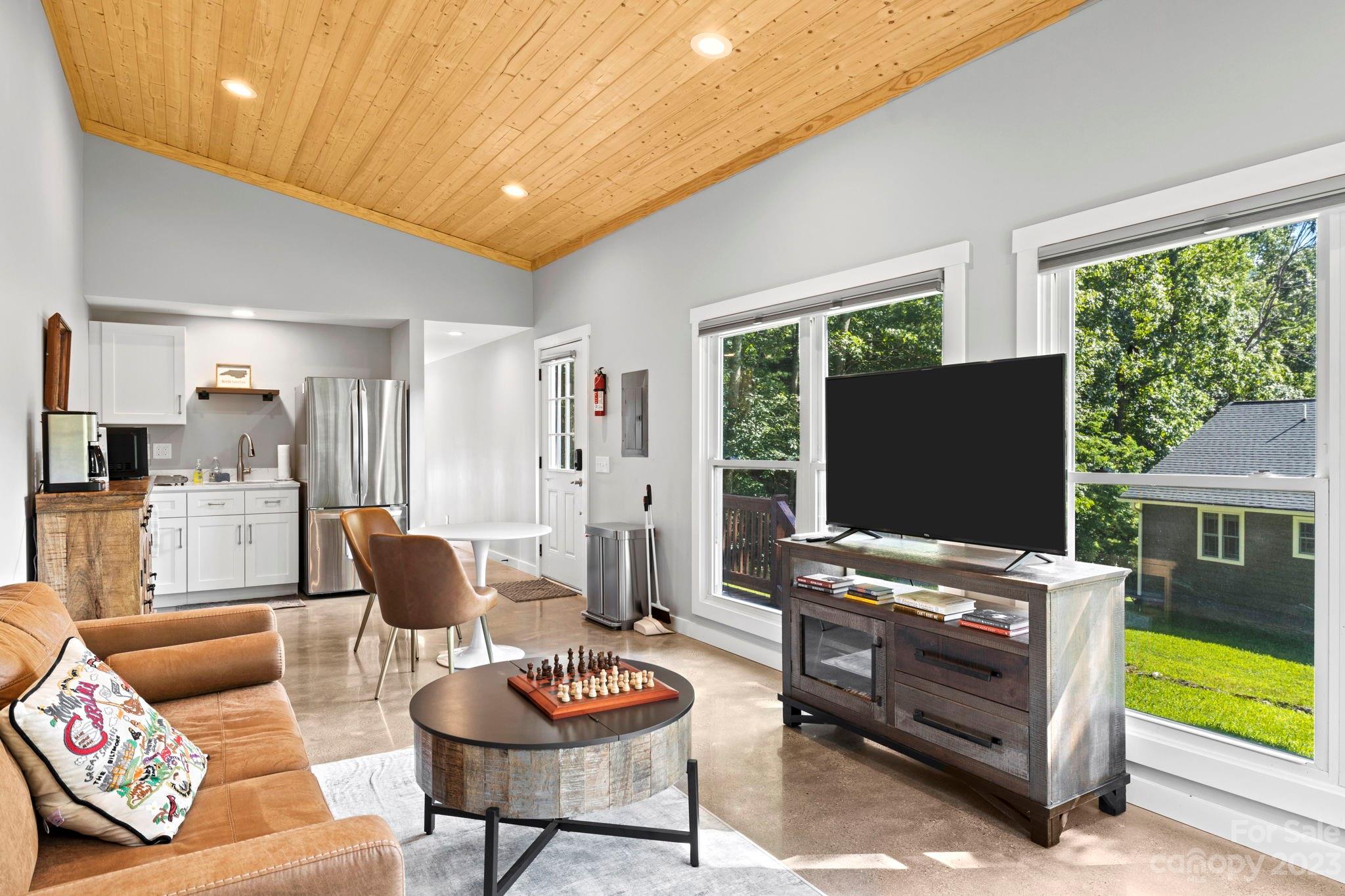 188 White Oak Gap Road Asheville, NC 28803 - Photo 40 of 48 a living room with furniture and a flat screen tv